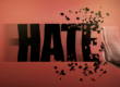 A raised hand breaks apart the word “HATE,” symbolising the rejection and prevention of hate crime