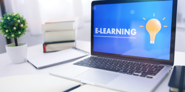 Laptop displaying an e-learning course, representing flexible online training for busy health and social care teams